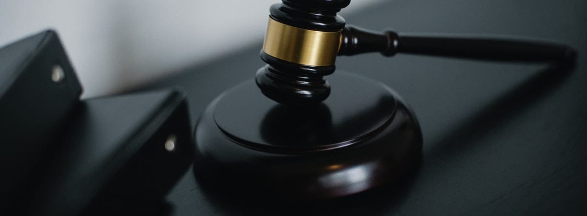 Lifetime Withdrawal from Industry A judge's gavel striking to make a decision, symbolizing legal authority, justice, and the finalization of important matters.